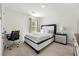 Bedroom features a modern bed, bedside table, and a desk, offering a stylish and functional space at 1961 Vidalia Ct, Dacula, GA 30019