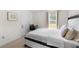 Bedroom features a modern bed, bedside table, and a desk, offering a stylish and functional space at 1961 Vidalia Ct, Dacula, GA 30019