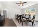 Bright dining room features a wood table, ceiling fan, and a window with natural light at 1961 Vidalia Ct, Dacula, GA 30019