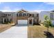 Charming two-story brick home featuring a two-car garage and manicured front lawn at 1961 Vidalia Ct, Dacula, GA 30019