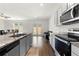Modern kitchen with gray cabinets, stainless steel appliances, and granite countertops at 1961 Vidalia Ct, Dacula, GA 30019