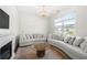 Bright living room featuring a decorative chandelier, fireplace, and hardwood floors at 1961 Vidalia Ct, Dacula, GA 30019