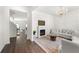Bright living room featuring a decorative chandelier, fireplace, and hardwood floors at 1961 Vidalia Ct, Dacula, GA 30019