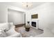 Bright living room featuring a decorative chandelier, fireplace, and hardwood floors at 1961 Vidalia Ct, Dacula, GA 30019