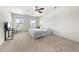 Spacious main bedroom features neutral walls, carpet, TV and natural light from two windows at 1961 Vidalia Ct, Dacula, GA 30019