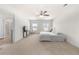 Open main bedroom featuring neutral walls, carpet, TV and natural light from two windows at 1961 Vidalia Ct, Dacula, GA 30019