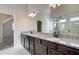 Bathroom featuring double sink vanity with granite countertop and large mirror at 3900 Ivy Cottage Dr, Snellville, GA 30039