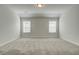 Spacious bedroom with neutral carpet, two windows with blinds, and ample natural light at 3900 Ivy Cottage Dr, Snellville, GA 30039