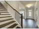 Elegant foyer showcasing wooden stairs, hardwood floors, and a front door at 3900 Ivy Cottage Dr, Snellville, GA 30039