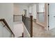 Second floor hallway landing features wooden railing with metal spindles and carpeted floors at 3900 Ivy Cottage Dr, Snellville, GA 30039