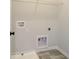 Functional laundry room features grey flooring, white walls, sink, and wire shelving for extra storage at 3900 Ivy Cottage Dr, Snellville, GA 30039