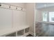 Mudroom with built-in bench seating, storage cubbies, and hanging hooks for easy organization at 3900 Ivy Cottage Dr, Snellville, GA 30039