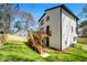 Expansive backyard showcasing a modern two-story home with a private wooden deck and lush green lawn at 608 S Evelyn Nw Pl, Atlanta, GA 30318