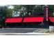 Exterior view of the Bankhead Restaurant featuring outdoor dining area, vibrant awnings, and street parking at 608 S Evelyn Nw Pl, Atlanta, GA 30318