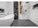Luxurious bathroom showcasing a freestanding tub, sleek shower, mosaic tile, and modern fixtures at 608 S Evelyn Nw Pl, Atlanta, GA 30318