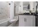 Cozy bathroom with marble tile, shower-tub combination, vanity, and illuminated mirror at 608 S Evelyn Nw Pl, Atlanta, GA 30318