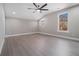 Spacious bedroom with vaulted ceilings, ample natural light, ceiling fan, and hardwood floors at 608 S Evelyn Nw Pl, Atlanta, GA 30318