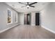 Bright bedroom with windows, ceiling fan, closet, and hardwood flooring at 608 S Evelyn Nw Pl, Atlanta, GA 30318