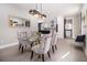 The dining room features a glass table, plush seating, and modern chandelier with kitchen access at 608 S Evelyn Nw Pl, Atlanta, GA 30318