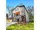 Inviting two-story home featuring a charming porch, a well-maintained lawn, and modern architectural details at 608 S Evelyn Nw Pl, Atlanta, GA 30318