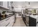 This kitchen features stainless steel appliances, black and white cabinetry, and granite countertops at 608 S Evelyn Nw Pl, Atlanta, GA 30318