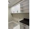 This laundry room boasts storage cabinets, tile flooring, and black granite countertops at 608 S Evelyn Nw Pl, Atlanta, GA 30318
