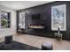Chic living room featuring a fireplace, a black accent wall, and ample natural light at 608 S Evelyn Nw Pl, Atlanta, GA 30318