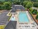 Aerial view of community pool with lounge chairs, splash area, and parking at 7545 Brookwood Way, Cumming, GA 30041