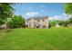 Wide shot of the home and expansive backyard with well manicured lawn at 7545 Brookwood Way, Cumming, GA 30041