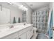 Bathroom featuring a double sink vanity, a large mirror, and a shower and tub combination at 7545 Brookwood Way, Cumming, GA 30041