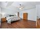 Spacious bedroom featuring hardwood floors, tray ceilings, and ample natural light at 7545 Brookwood Way, Cumming, GA 30041