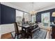 This dining area features a table with seating for six, hardwood floors, and a view into the main living area at 7545 Brookwood Way, Cumming, GA 30041