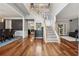 Elegant foyer with hardwood floors, staircase, and views into the dining and living areas at 7545 Brookwood Way, Cumming, GA 30041