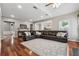 Large living area with hardwood floors, an area rug, and a comfortable sectional couch at 7545 Brookwood Way, Cumming, GA 30041