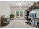 Well-lit office space featuring built-in shelving, ceiling fan, and neutral carpet at 7545 Brookwood Way, Cumming, GA 30041