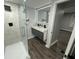 Modern bathroom featuring a glass-enclosed shower, double sink vanity, and illuminated mirror with updated fixtures at 2040 Penelope Nw St, Atlanta, GA 30314