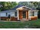 Charming home showcasing a wood facade, inviting entrance, and lush greenery at 2040 Penelope Nw St, Atlanta, GA 30314
