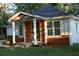 Charming single-story home featuring wood and white accents, a covered porch, and a well-maintained front yard at 2040 Penelope Nw St, Atlanta, GA 30314