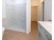 Modern bathroom featuring a marbled glass shower, gray vanity, and wood flooring at 27 Hazel St, Porterdale, GA 30014