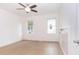 Well-lit bedroom featuring light wood flooring and modern ceiling fan at 27 Hazel St, Porterdale, GA 30014