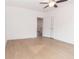 Bright bedroom with a ceiling fan and light wood flooring, leading into another room at 27 Hazel St, Porterdale, GA 30014