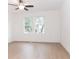 Spacious bedroom with light wood flooring, natural light, and modern ceiling fan at 27 Hazel St, Porterdale, GA 30014