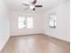 Bright bedroom featuring natural light, ceiling fan, and wood-look flooring at 27 Hazel St, Porterdale, GA 30014