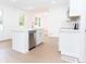 Modern kitchen featuring white cabinets, stainless steel appliances, and an island at 27 Hazel St, Porterdale, GA 30014