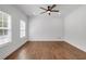 Bright, minimalist bedroom with hardwood floors and ceiling fan at 552 Steels Bridge Rd, Canton, GA 30114