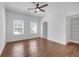 Bright, airy bedroom with hardwood floors, a ceiling fan, and natural light at 552 Steels Bridge Rd, Canton, GA 30114