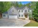 Beautiful two-story home with a manicured lawn, attached garage and inviting front porch at 552 Steels Bridge Rd, Canton, GA 30114