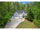 Aerial shot of home featuring a long driveway and wooded surroundings at 552 Steels Bridge Rd, Canton, GA 30114