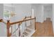 Elegant foyer with hardwood floors, chandelier, and a staircase with wood and white railing at 552 Steels Bridge Rd, Canton, GA 30114