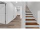 Hallway featuring new wood floors, white walls, and a stairway at 552 Steels Bridge Rd, Canton, GA 30114